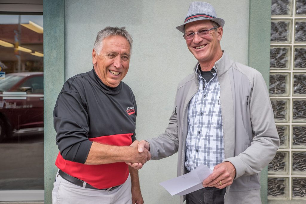 Ken Baker, sales representative with the Osoyoos Times, presents the winning two tickets to the upcoming CFL game between the B.C. Lions and Saskatchewan Roughriders to Osoyoos resident John Katerenchuk. The tickets were drawn at the Osoyoos Times office last week. Katerenchuk and his wife Nancy also won an overnight stay at the Rosedale on Robson Hotel. The game takes place this Saturday, Oct. 3 in Vancouver. (Richard McGuire photo)