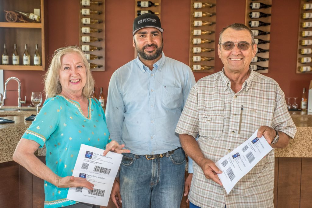 Maggie Yanor (left) and Albert Korte (right) of Osoyoos were the lucky winners of two four-day passes each to the Rockin’ River Musicfest in Merritt this weekend. Congratulating the winners is Manmohan Gill, owner of Bordertown Vineyards and Estate Winery, which sponsored the contest in conjunction with the Osoyoos Times. Participants filled out entry forms in the Osoyoos Times and took them to Bordertown Vineyards and Estate Winery for the draw. The new winery’s grand opening is Aug. 8 and the winery is located at 9140 92nd Avenue on the east side of Highway 97 north of the Highway 3 intersection. (Richard McGuire photo)