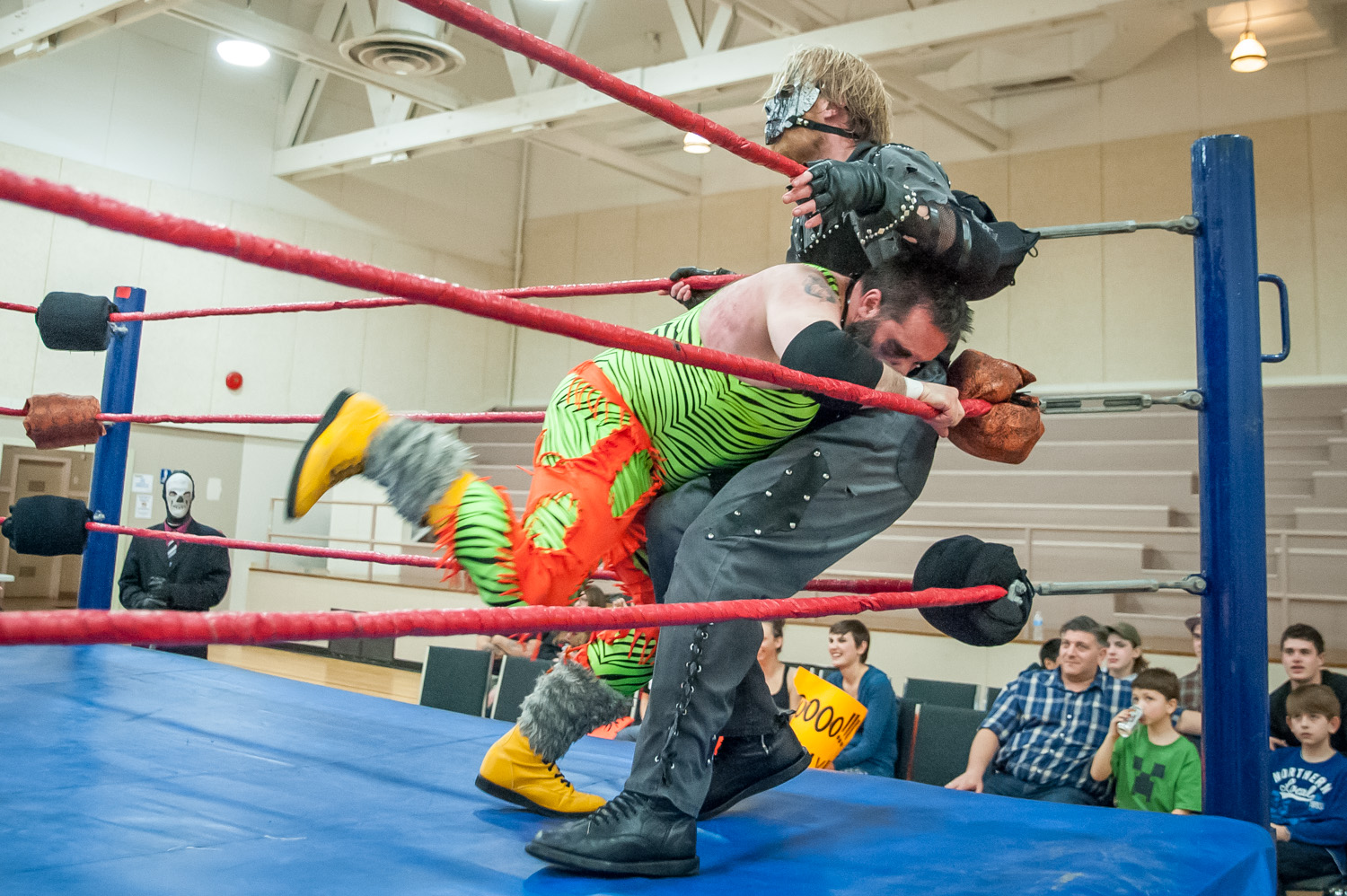 Mad Dog Marty Sugar plunges at the six-foot-eight masked Cremator Von Slasher during the performance by Big West Wrestling at the Sonora Community Centre Sunday night. (Richard McGuire photo)