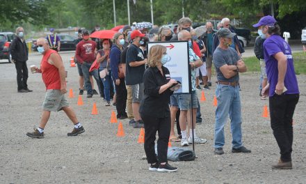 Deluge doesn’t stop outdoor vaccine clinic