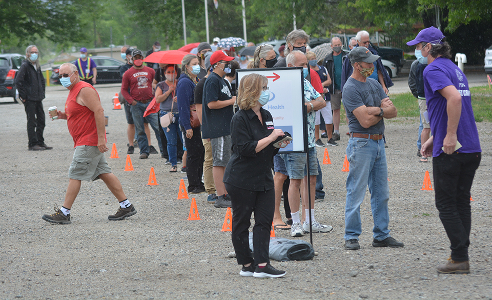 Deluge doesn’t stop outdoor vaccine clinic