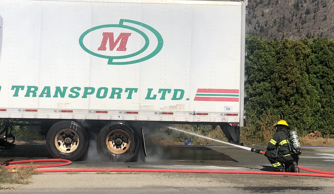 Firefighters extinguish smoking semi-trailer truck wheels